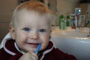 What makes you stronger when you break it? Photo baby with toothbrush
