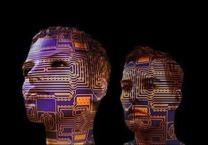 Intelligence is a movable feast! - Image of two heads with circuit boards