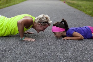 You can be glad about that - photo of mother and daughter doing push-ups